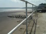 Beach front safety barrier made with Interclamp tube fittings overlooking sand and sea